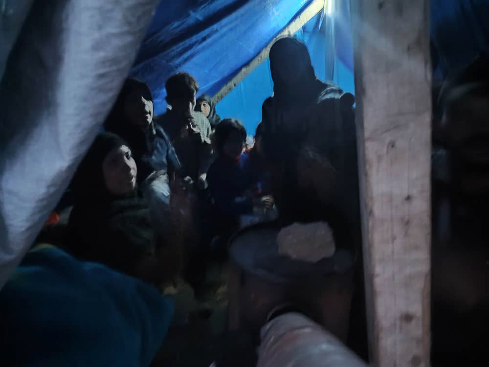 people inside a tent in the dark