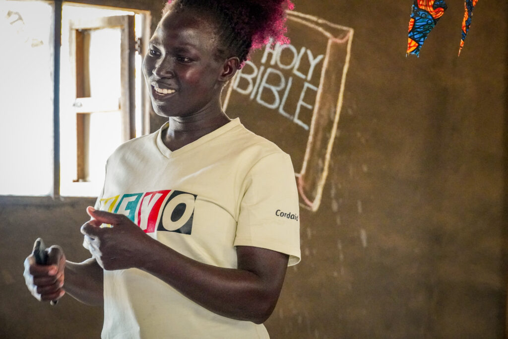 Ugandan youth presenting in a class room.