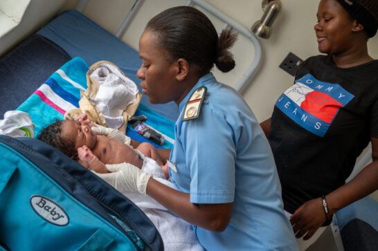 A Zimbabwean nurse taking care of a newborn.