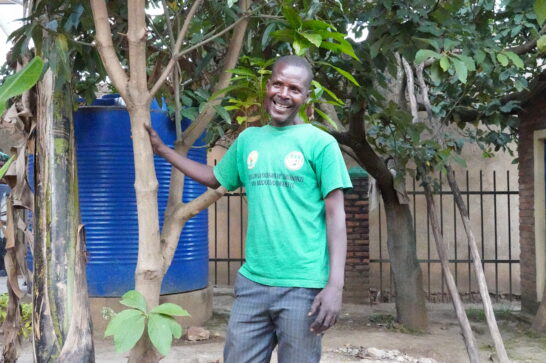 A Rwandan farmer amid his trees.
