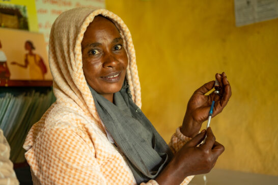 Health worker Mitke Gizaw explains the vaccination process to caregivers, building trust and ensuring children receive life-saving immunisations. Jimma, Ethiopia.