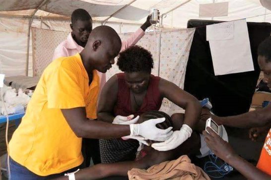 woman during delivery assisted by health care workers