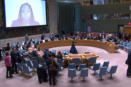 big screen in the UN security Council main room, showing the face of a young woman