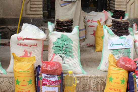 Big bags of sugar and other food items on a porch