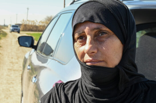 woman in front of car