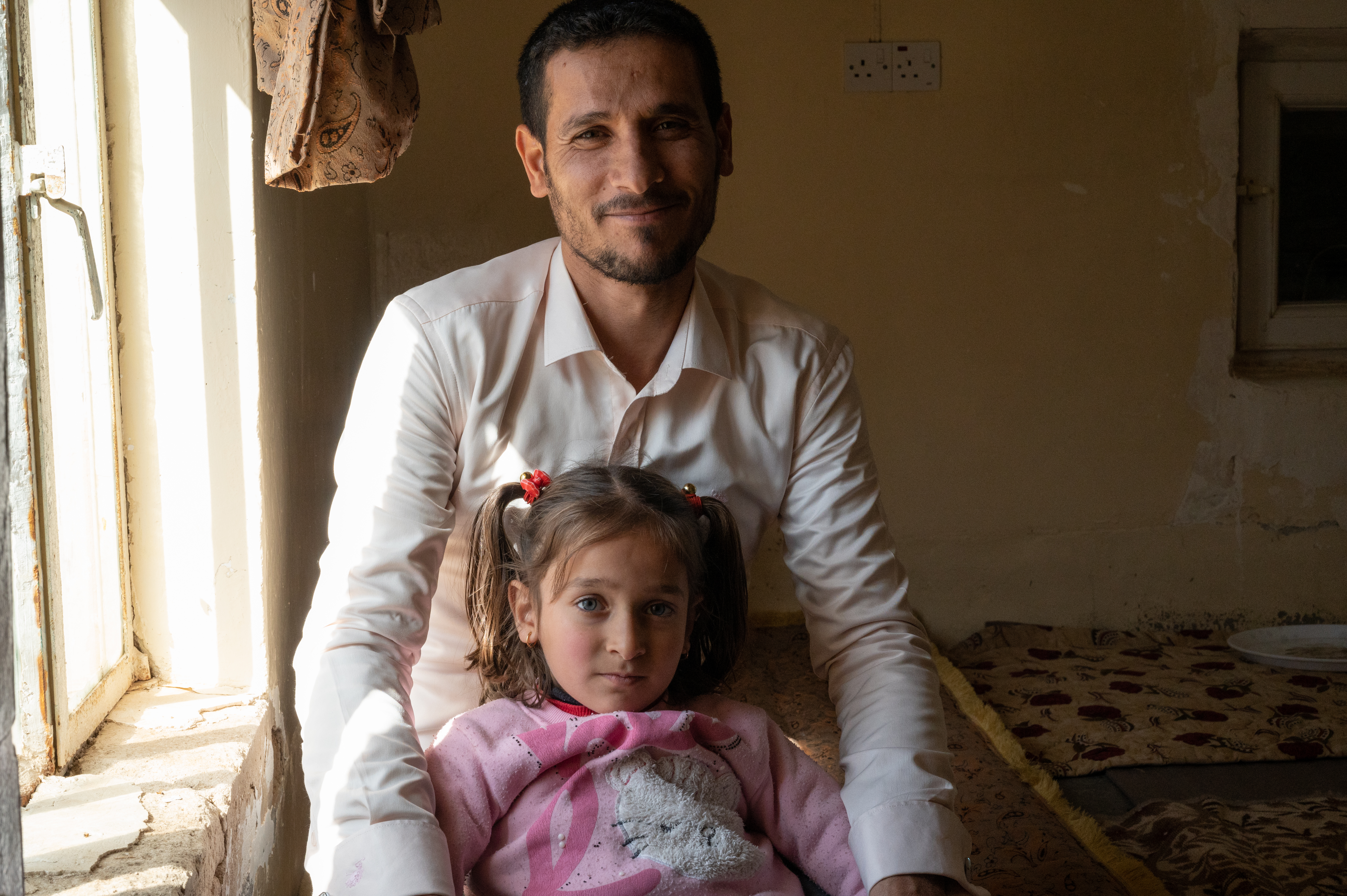 man with young girl inside a room