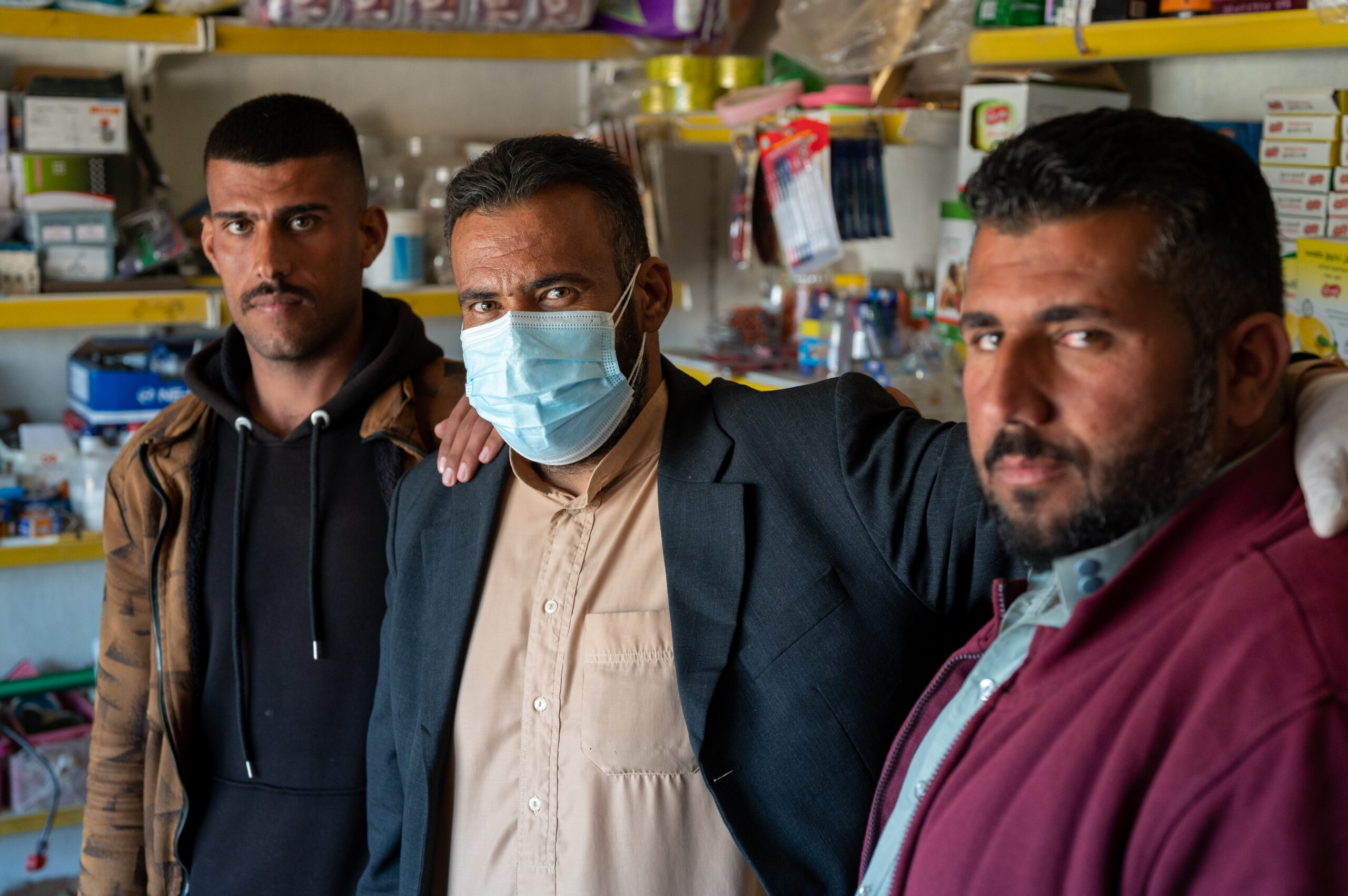 three men inside shop