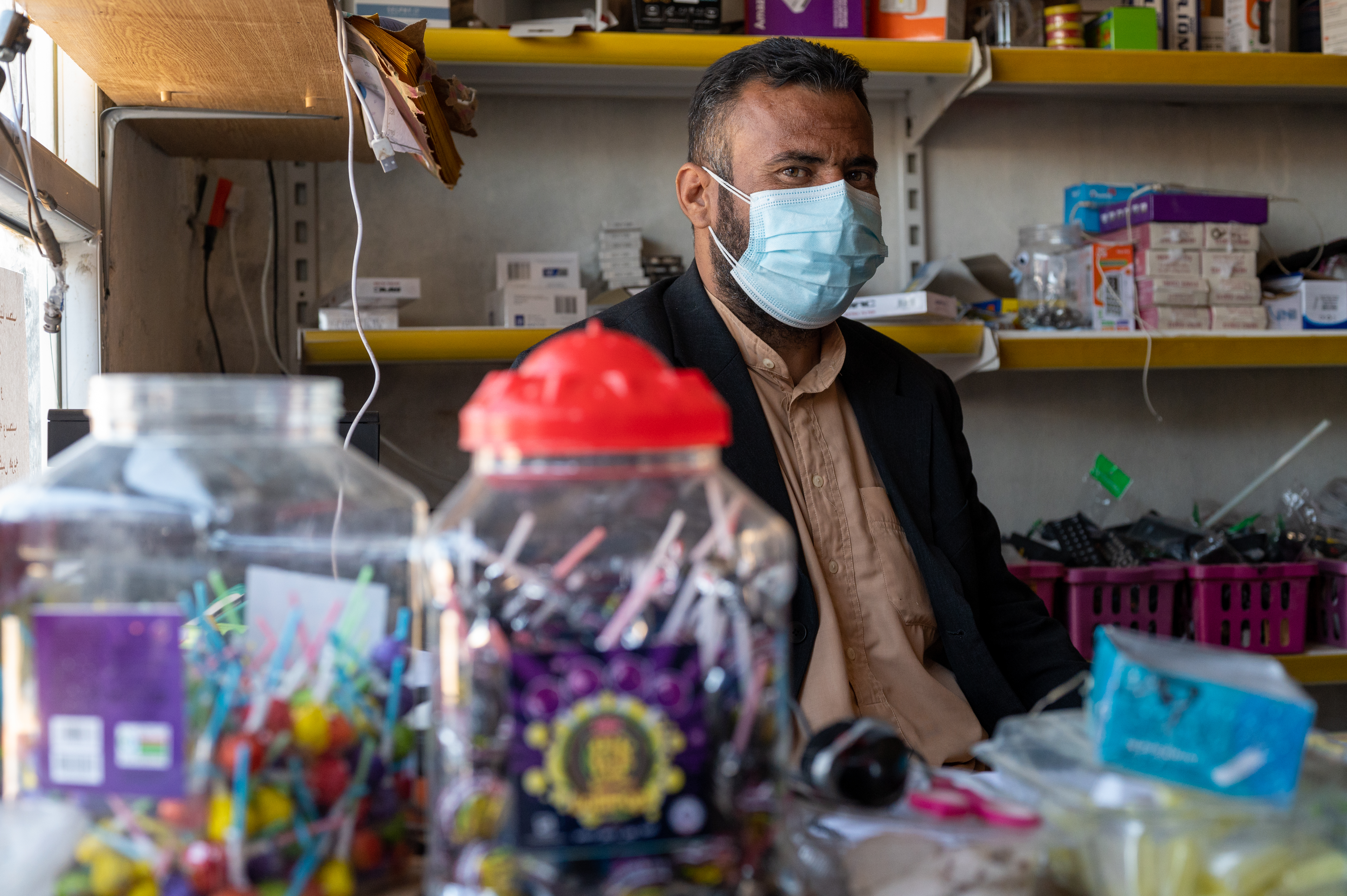 man in shop behind counter