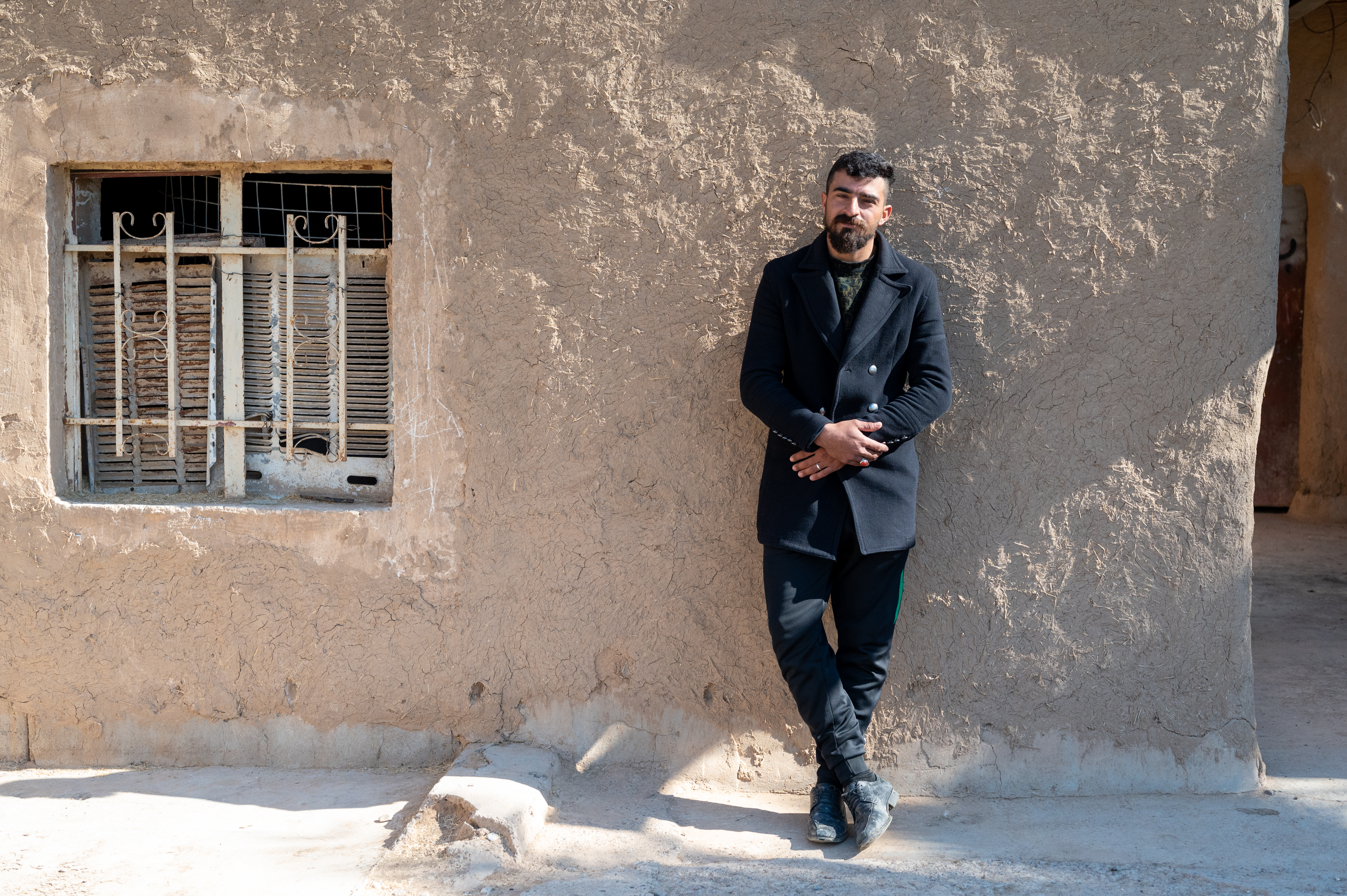 man standing against wall