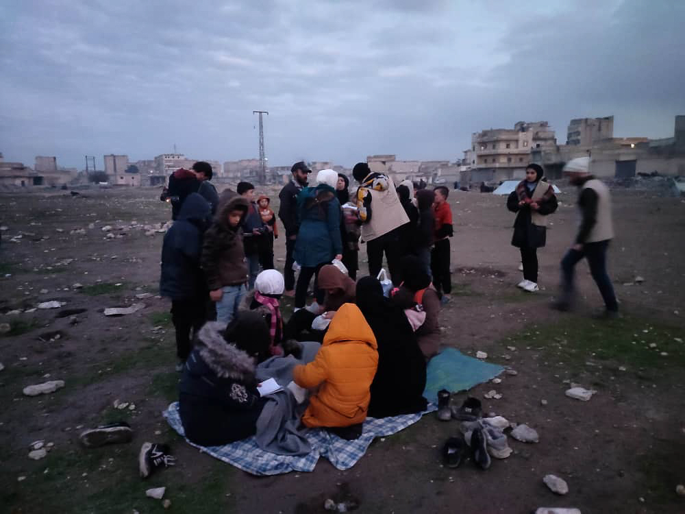 people outside standing sitting