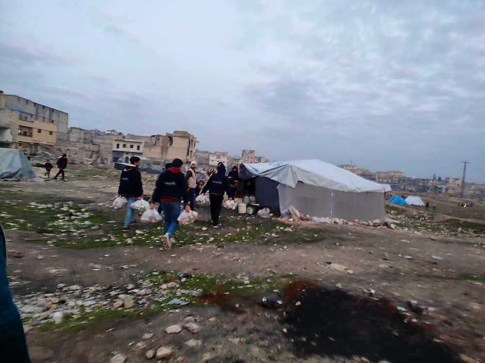 tent people carrying bags