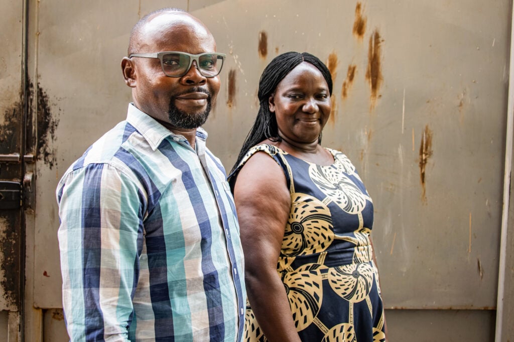 man and woman standing and looking into the camera smiling