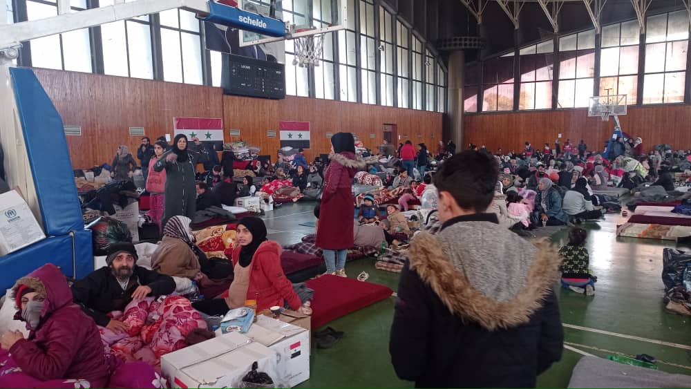 people inside a sports hall mattrasses on the ground