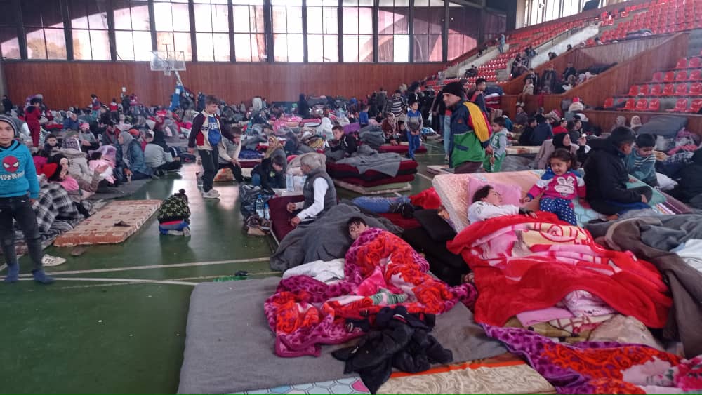 people inside a sports hall mattrasses on the ground