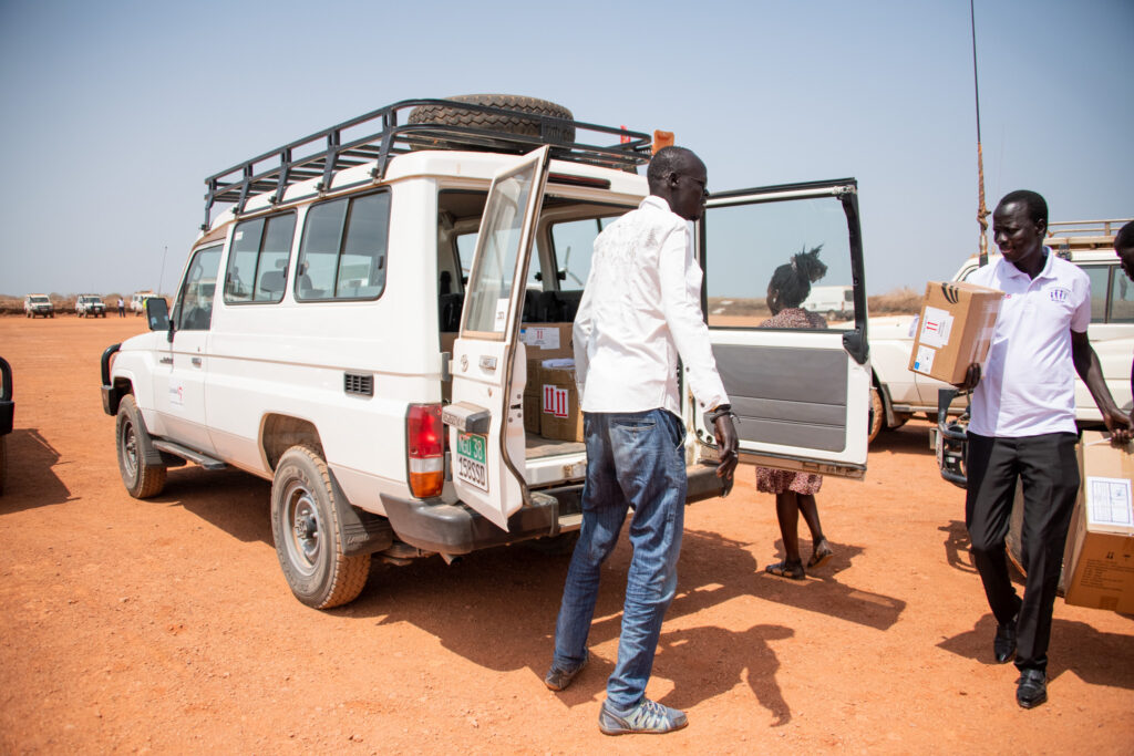 A jeep with health workers in the arid land of South Sudan.