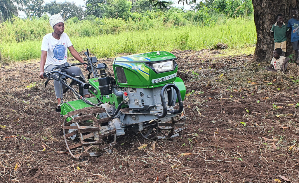 woman an a tractor in a farm field