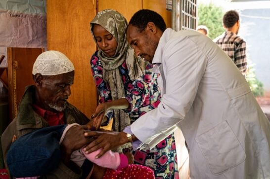 A healthcare worker treating a patient